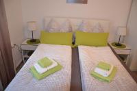 A bed or beds in a room at Pension & Restaurant La Amalia