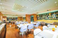 a restaurant with white tables and white chairs at Hotel XYZ in Tacloban