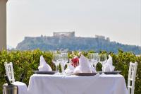 una mesa blanca con copas de vino y servilletas. en Crystal City Hotel, en Atenas