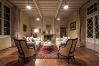 a living room with a couch and chairs and a fireplace at Château Sigalas Rabaud in Bommes