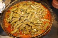 a bowl of pasta with mushrooms and tomato sauce at Yeşilyurt Residence in İzmir