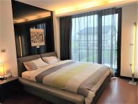 a bedroom with a large bed with a large window at The Designer&#39;s House in Wujie