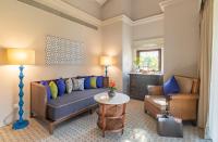 a living room with a couch and a chair at Taj Holiday Village Resort & Spa, Goa in Candolim