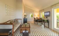 a living room with a couch and a piano at Taj Holiday Village Resort & Spa, Goa in Candolim