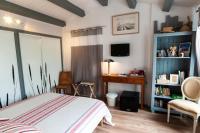 a bedroom with a bed and a desk in it at Les Yeux Bleus Bed &amp; Breakfast in Noirmoutier-en-l&#39;lle