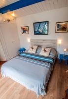a bedroom with a large bed in a room at Les Yeux Bleus Bed &amp; Breakfast in Noirmoutier-en-l&#39;lle