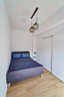 Posteľ alebo postele v izbe v ubytovaní Apartamenty Muzyczna 14