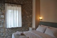 Posteľ alebo postele v izbe v ubytovaní Petras Gi - Stone Houses
