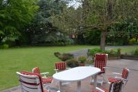 a white table and chairs on a patio at La Coulonnière in Wismes