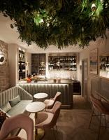 a restaurant with a couch and tables and a bar at The Melegran in Rovinj