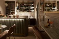 a bar with chairs and a counter in a room at The Melegran in Rovinj
