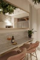 a kitchen with a counter with two chairs and a mirror at The Melegran in Rovinj