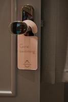 a doorhandle with a sign that says gone swimming at The Melegran in Rovinj