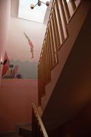 a stairway with a wall mural of a woman on the ceiling at The Melegran in Rovinj