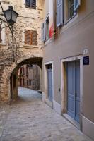 an alley in an old town with blue doors at The Melegran in Rovinj