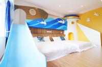a bedroom with a bed with a painting of a lighthouse at 36 Lighthouse in Hualien City