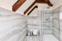 a bathroom with a shower and a toilet at Hotel Garden Court in Prague