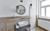 a bathroom with a sink and a mirror on the wall at Hotel Garden Court in Prague