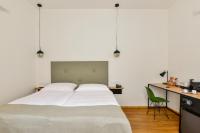 a bedroom with a large bed and a desk at Hotel Garden Court in Prague
