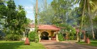 a yellow house with a red roof in a yard at Taj Holiday Village Resort & Spa, Goa in Candolim