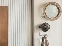 a mirror hanging on a wall next to a radiator at Khan Hotel in Kaohsiung