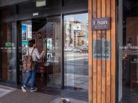 a woman looking in the window of a store at Khan Hotel in Kaohsiung