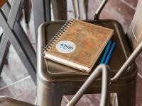 a notebook sitting on top of a chair at Khan Hotel in Kaohsiung