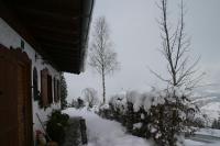 a yard covered in snow next to a house at Ferienhaus Soregina in Ellmau