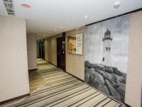 a hallway with a wall mural of a lighthouse at Khan Hotel in Kaohsiung