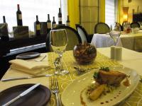 a plate of food on a table with wine glasses at Hotel Fundador in Santiago