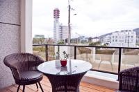 a table and chairs on a balcony with a view at Antlers Guest House in Taitung City