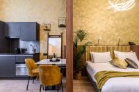 a bedroom with a bed and a table and a kitchen at Leopold Hotel Oudenaarde in Oudenaarde