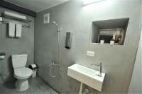 a bathroom with a sink and a toilet and a mirror at Inn Cube - Taipei Main Station in Taipei