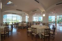 a banquet hall with tables and chairs in a building at Hermitage Hotel in Silvi Marina