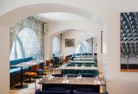 a row of tables and chairs in a restaurant at Galleria Vik Milano - Townhouse Galleria - Small Luxury Hotels of the World in Milan