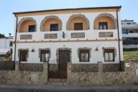 an old house with a stone wall at El Corral de Dolores in El Bosque