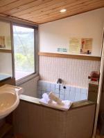 a bathroom with a sink and a bath tub at New Life Hot Spring Resort in Yuli
