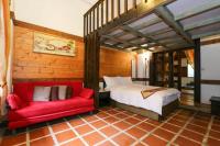 a bedroom with a bed and a red couch at New Life Hot Spring Resort in Yuli