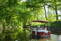 a group of people riding a boat on a river at Rives Nature in La Gacilly
