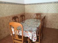 a table with three chairs and a table and a table and chairs at El Corral de Dolores in El Bosque