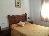 a bedroom with a bed with a pillow on it at El Corral de Dolores in El Bosque