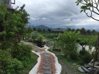 a garden with a stone path and a gazebo at Beautiful Yilan Resort in Dongshan