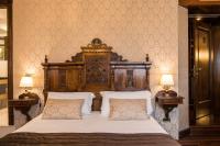 a bedroom with a large wooden bed with two pillows at Palazzo Bembo - Exclusive Accommodation in Venice