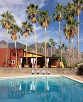 una piscina con palmeras al fondo en Tripui Hotel, en Puerto Escondido
