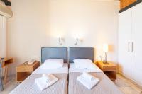 Posteľ alebo postele v izbe v ubytovaní Olympic Suites