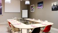 a classroom with tables and chairs and a whiteboard at Grand Hôtel d&#39;Orléans in Toulouse