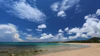 a view of a beach with a blue sky and clouds at Tz Shin Resort Hostel in Kenting