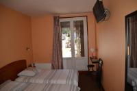 a hotel room with two beds and a window at Le Cheval Noir Hôtel Paris Pantin in Pantin