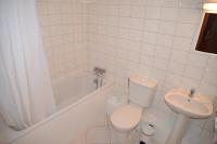 a white bathroom with a toilet and a sink at Le Cheval Noir Hôtel Paris Pantin in Pantin