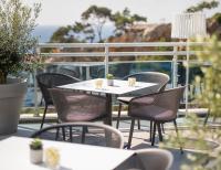 a table and chairs on a balcony with the ocean at Hotel Bellevue Dubrovnik in Dubrovnik
